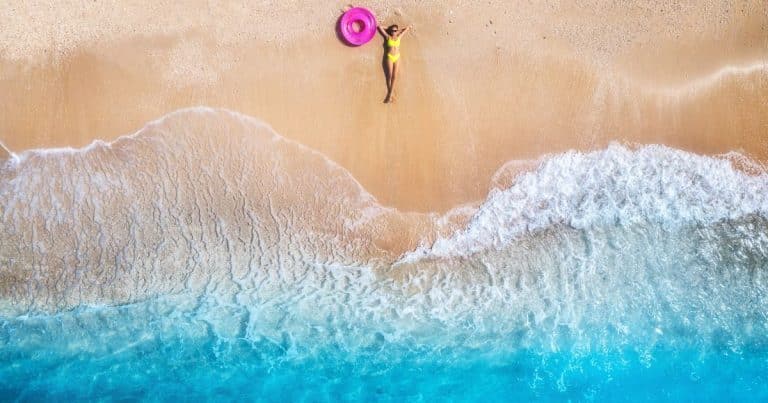 Aerial,View,Of,The,Lying,Beautiful,Young,Woman,With,Pink